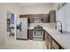 Well-lit kitchen with stainless steel appliances, ample counter space, and dark wood cabinets at 1709 Autumn Rust Dr, Las Vegas, NV 89119