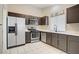 Functional kitchen features stainless steel appliances, tile floors, and ample cabinet space at 1709 Autumn Rust Dr, Las Vegas, NV 89119