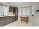 Bright kitchen featuring dark cabinets, a breakfast nook, and natural light at 1709 Autumn Rust Dr, Las Vegas, NV 89119