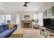 Spacious living room with a stone fireplace, plush seating, and natural light at 1709 Autumn Rust Dr, Las Vegas, NV 89119