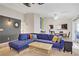 Comfortable living room with a blue sectional and a bamboo coffee table at 1709 Autumn Rust Dr, Las Vegas, NV 89119