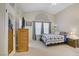 Spacious main bedroom featuring vaulted ceilings, plush carpeting, and large windows at 1709 Autumn Rust Dr, Las Vegas, NV 89119