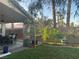 Backyard with a covered patio, dining area, and lush greenery at 1800 Quail Point Ct, Las Vegas, NV 89117