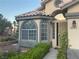 Inviting entryway featuring arched windows and a secure screen door at 1800 Quail Point Ct, Las Vegas, NV 89117