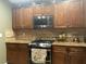 A well-equipped kitchen with stainless steel appliances, granite countertops, and wood cabinetry at 1800 Quail Point Ct, Las Vegas, NV 89117