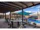Outdoor lounge area with pergola, patio furniture, and a view of the sparkling pool at 1988 N Moapa Valley Blvd, Logandale, NV 89021