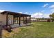 View of the backyard with a pergola covered patio and a well manicured lawn at 1988 N Moapa Valley Blvd, Logandale, NV 89021