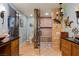 Well-appointed bathroom with travertine tile, dual vanities, glass shower and turtle themed decor at 1988 N Moapa Valley Blvd, Logandale, NV 89021