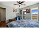Comfortable bedroom featuring wood floors, a large window, and a blue vanity with mirror at 1988 N Moapa Valley Blvd, Logandale, NV 89021