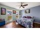 Bright bedroom with large windows overlooking a lake view, hardwood floors and ceiling fan at 1988 N Moapa Valley Blvd, Logandale, NV 89021