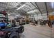 Large metal garage featuring vehicle, lawn care equipment, and ample storage space at 1988 N Moapa Valley Blvd, Logandale, NV 89021