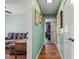 Inviting hallway with hardwood floors and art leading to comfortable living spaces at 1988 N Moapa Valley Blvd, Logandale, NV 89021