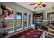 Bright office with floor to ceiling windows overlooking the home's backyard and a full bookcase at 1988 N Moapa Valley Blvd, Logandale, NV 89021