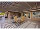 Outdoor patio area with a dining table, chairs, grill and a decorative pergola, perfect for entertaining at 1988 N Moapa Valley Blvd, Logandale, NV 89021