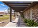 Covered patio extending from a brick home, creating a shaded retreat with a view of pastures at 1988 N Moapa Valley Blvd, Logandale, NV 89021
