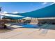 Sparkling pool with sunshades, stone accents, and ample deck space, perfect for summer relaxation and entertainment at 1988 N Moapa Valley Blvd, Logandale, NV 89021