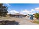 Wide view of house with long driveway, mature trees, and fenced perimeter at 1988 N Moapa Valley Blvd, Logandale, NV 89021