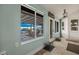 Bright sunroom view featuring tiled floors, windows to backyard, and stylish light fixture at 1988 N Moapa Valley Blvd, Logandale, NV 89021