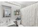 Bathroom featuring a gray vanity, framed mirror and decorative shelves at 234 Priority Point St, Henderson, NV 89012