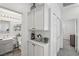 Hallway with white cabinets and decor leading to a bathroom and bedroom at 234 Priority Point St, Henderson, NV 89012