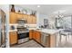 Bright kitchen featuring stainless steel appliances, wood cabinets, and white countertops at 234 Priority Point St, Henderson, NV 89012