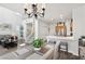 Bright living area features stairs, kitchen, and dining area with natural light at 234 Priority Point St, Henderson, NV 89012