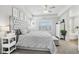 Bedroom featuring a tray ceiling, large bed and natural lighting at 234 Priority Point St, Henderson, NV 89012