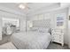 Bedroom featuring a tray ceiling, large bed and neutral decor at 234 Priority Point St, Henderson, NV 89012