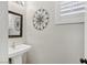 Powder room featuring a pedestal sink and decorative mirror at 234 Priority Point St, Henderson, NV 89012