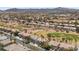 Panoramic aerial view of a residential neighborhood with mature trees and a golf course at 2445 Ping Dr, Henderson, NV 89074