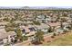 Expansive aerial shot of a residential community, lush golf course, and stunning mountain views at 2445 Ping Dr, Henderson, NV 89074