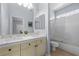 Bright bathroom with double sinks, a large mirror, and shower-tub combination at 2445 Ping Dr, Henderson, NV 89074