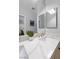 Elegant bathroom featuring double sinks with white marble countertops and modern fixtures at 2445 Ping Dr, Henderson, NV 89074