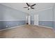Spacious bedroom featuring neutral carpet, a ceiling fan and two-tone paint at 2445 Ping Dr, Henderson, NV 89074