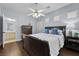 Serene bedroom with ensuite bath, wood floors, ceiling fan and natural light at 2445 Ping Dr, Henderson, NV 89074