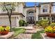 Charming front entrance with manicured lawn, brick pathway, and lush shrubbery leading to double doors at 2445 Ping Dr, Henderson, NV 89074