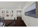 Elegant hallway featuring dark wood floors, niches for decor, and an art piece on the wall at 2445 Ping Dr, Henderson, NV 89074