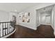 Bright hallway with dark wood floors and decorative niches with recessed lighting at 2445 Ping Dr, Henderson, NV 89074