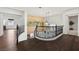 Open hallway area with dark wood floors and an elegant banister at 2445 Ping Dr, Henderson, NV 89074