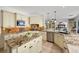 Open concept kitchen with granite countertops and stainless steel appliances at 2445 Ping Dr, Henderson, NV 89074