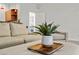 Close-up of a plant displayed in the living room with a couch and chair at 2445 Ping Dr, Henderson, NV 89074