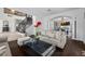 Bright, spacious living room, showcasing a staircase, hardwood floors and arched doorways to dining area at 2445 Ping Dr, Henderson, NV 89074