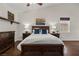 Beautiful main bedroom with dark wood floors, a ceiling fan, and custom shelfing at 2445 Ping Dr, Henderson, NV 89074