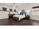 Spacious main bedroom featuring dark wood floors, a ceiling fan, and neutral paint at 2445 Ping Dr, Henderson, NV 89074