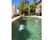 Backyard pool with a decorative waterfall feature and comfortable seating area at 2445 Ping Dr, Henderson, NV 89074