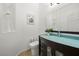 Stylish powder room featuring a unique glass countertop and modern fixtures at 2445 Ping Dr, Henderson, NV 89074