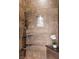 Shower featuring stone tile, shower niche, and black fixtures at 2445 Ping Dr, Henderson, NV 89074