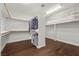 Walk-in closet with wood-look floors and wooden racks at 2445 Ping Dr, Henderson, NV 89074