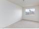 Bedroom features plush carpeting, neutral paint, and a window with neighborhood views at 3939 Jontue St, Las Vegas, NV 89115