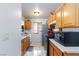 Galley kitchen featuring stainless steel refrigerator and tile flooring at 3939 Jontue St, Las Vegas, NV 89115